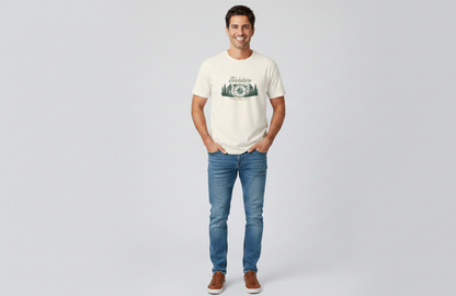 Man wearing a white t-shirt with a graphic design and blue jeans on a light gray background