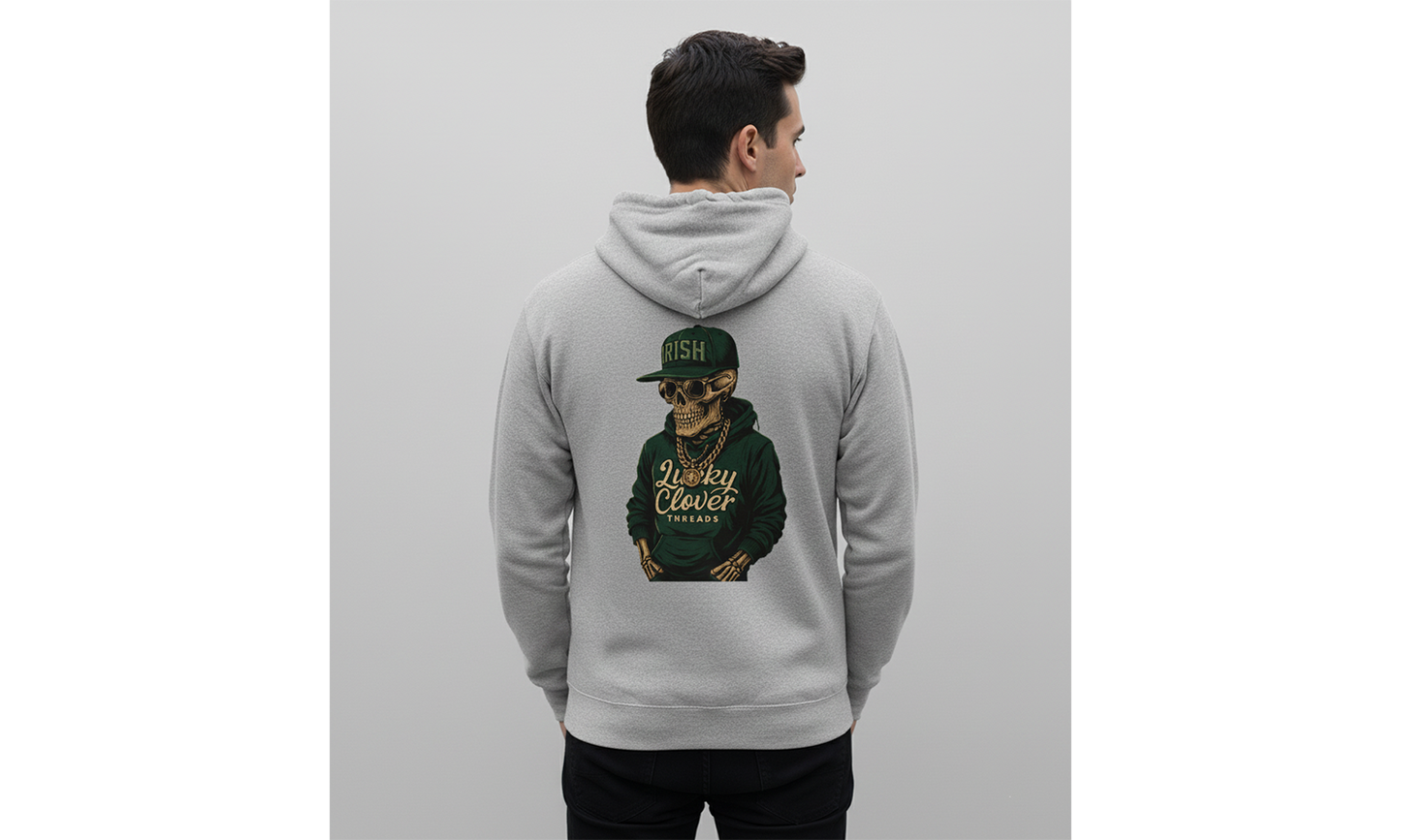 Person wearing a gray hoodie with a graphic of a person in a green cap on the back, against a light gray background