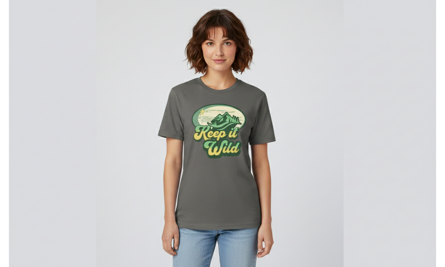 Woman wearing a gray t-shirt with 'Keep it Wild' graphic on a light gray background