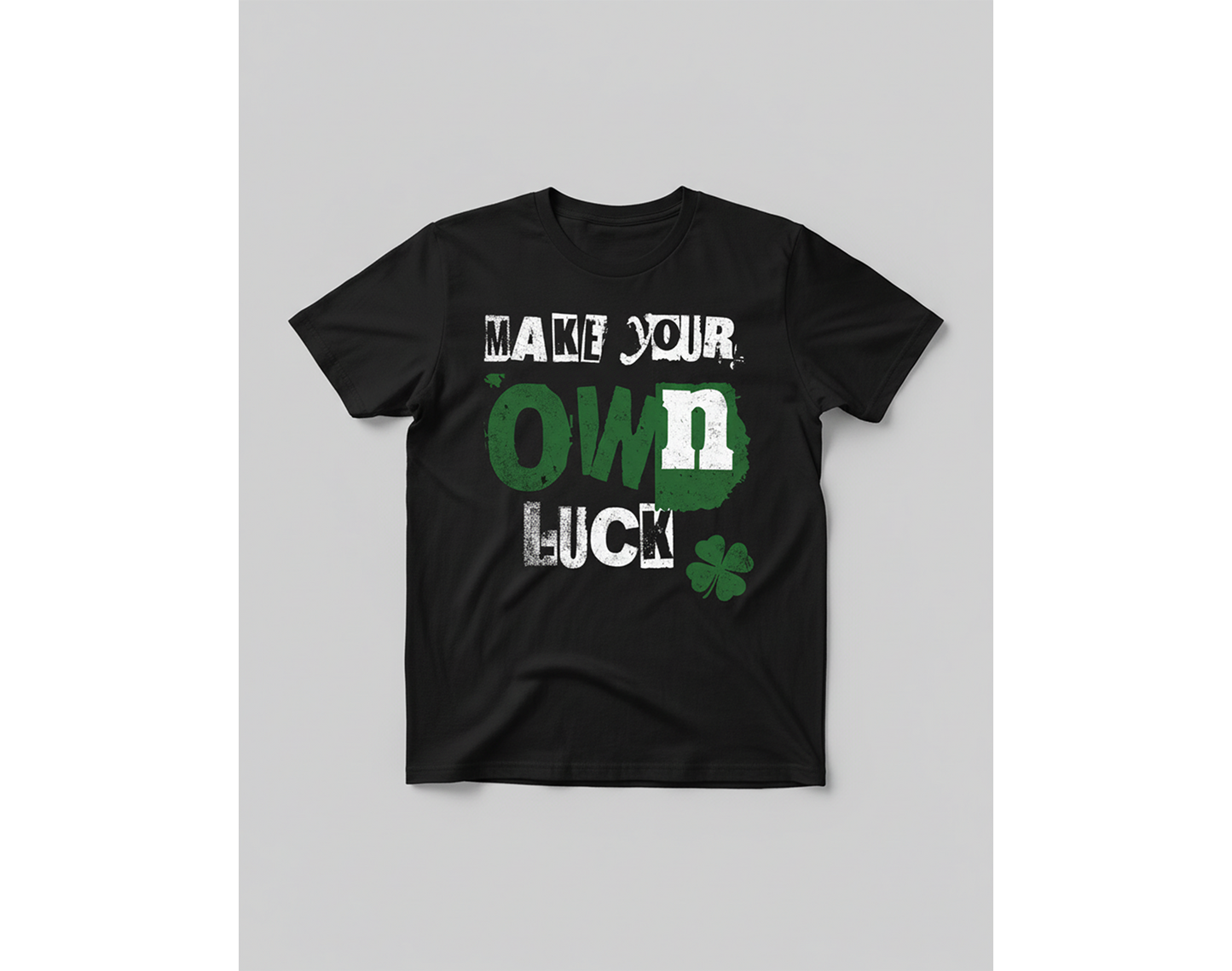 Black t-shirt with 'Make your own luck' text and clover graphic on a gray background
