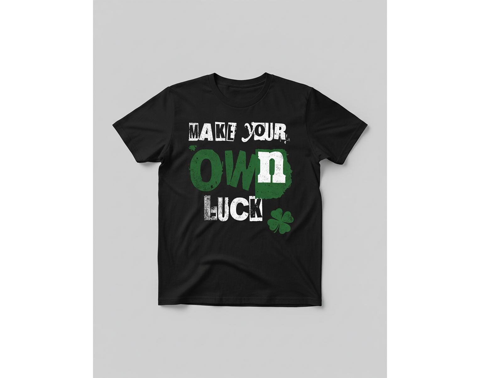 Black t-shirt with 'Make your own luck' text and clover graphic on a gray background